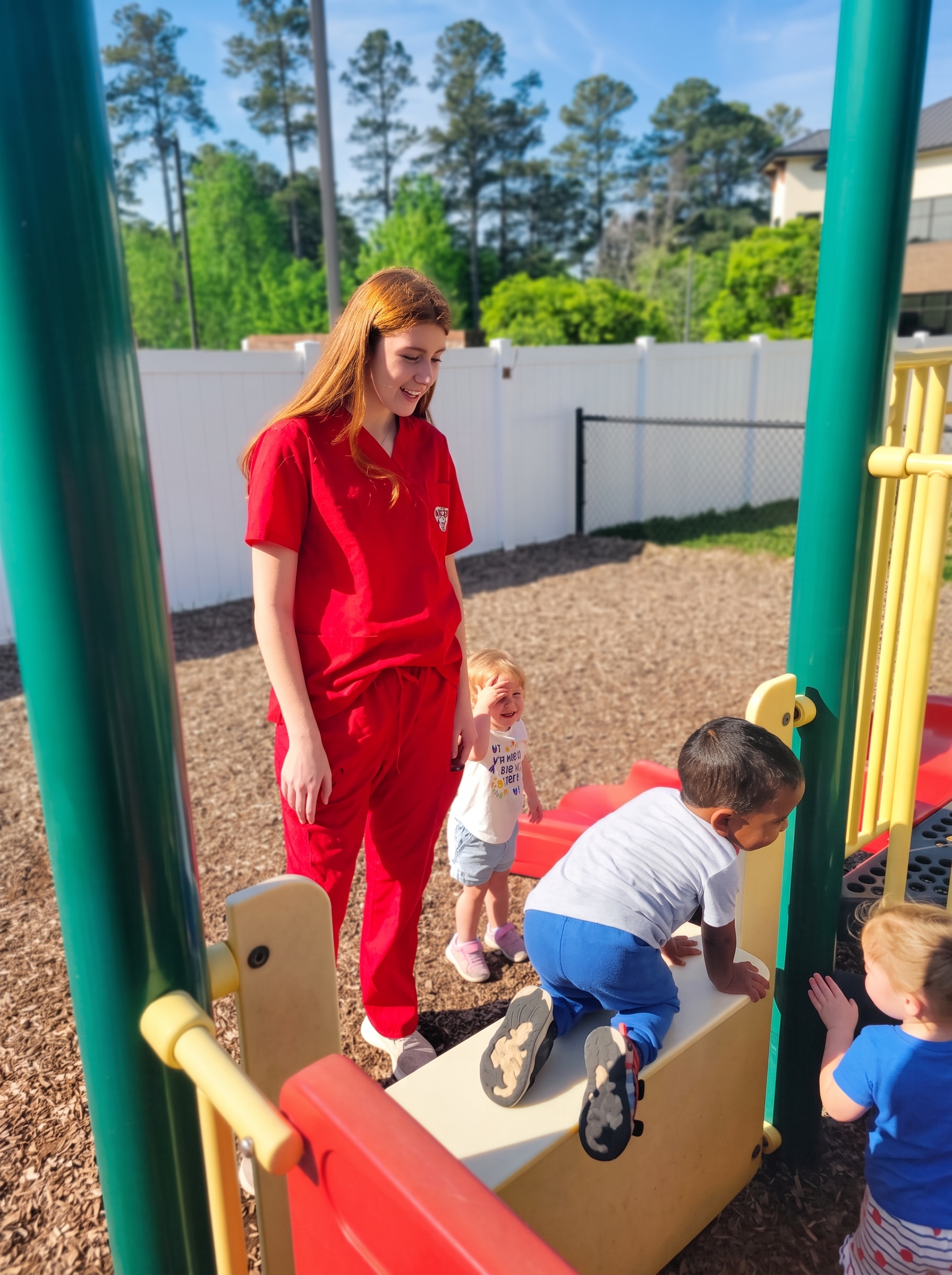 Elizabeth playing at playground with toddlers